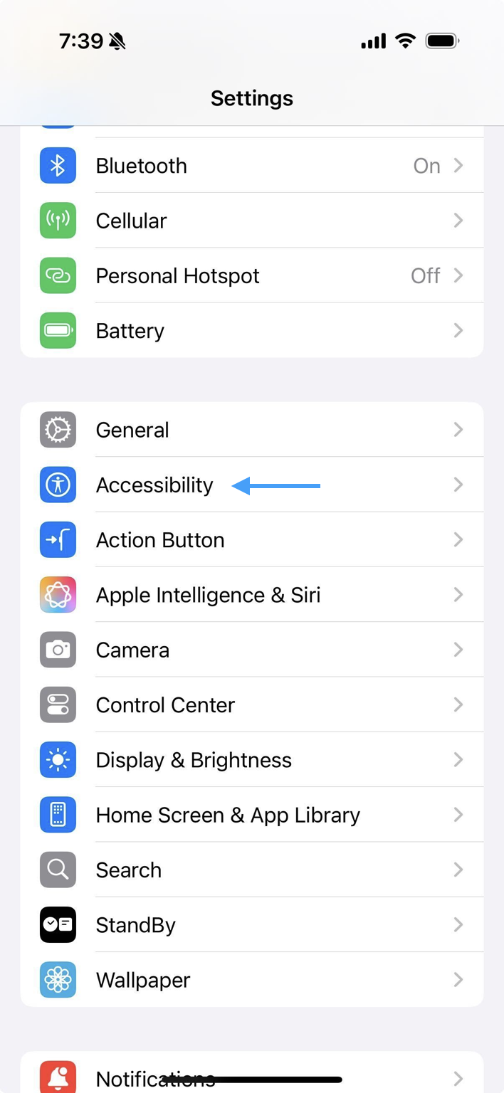 iPhone Setting menu with an arrow pointing to accessibility.